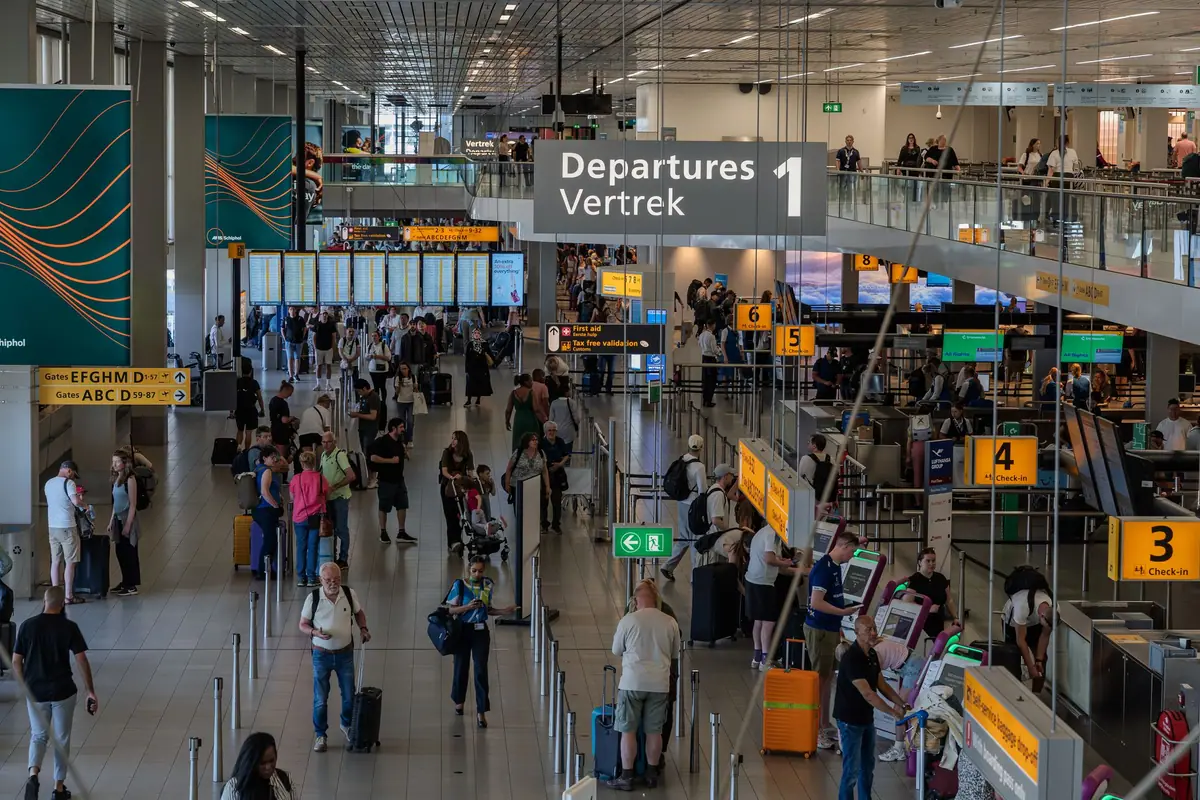 Travellers in an airport departure hall
