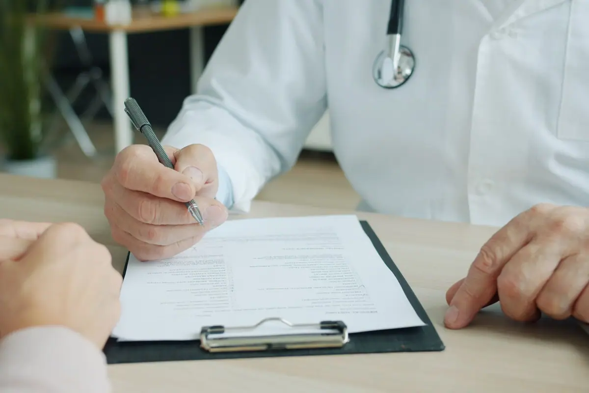 A doctor filling in a medical form for a patient