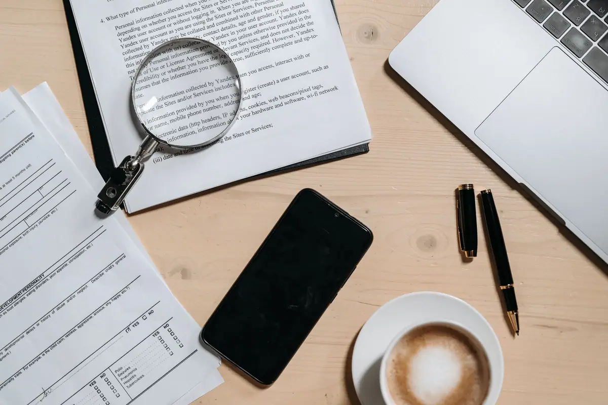 A magnifying glass over documents on a desk