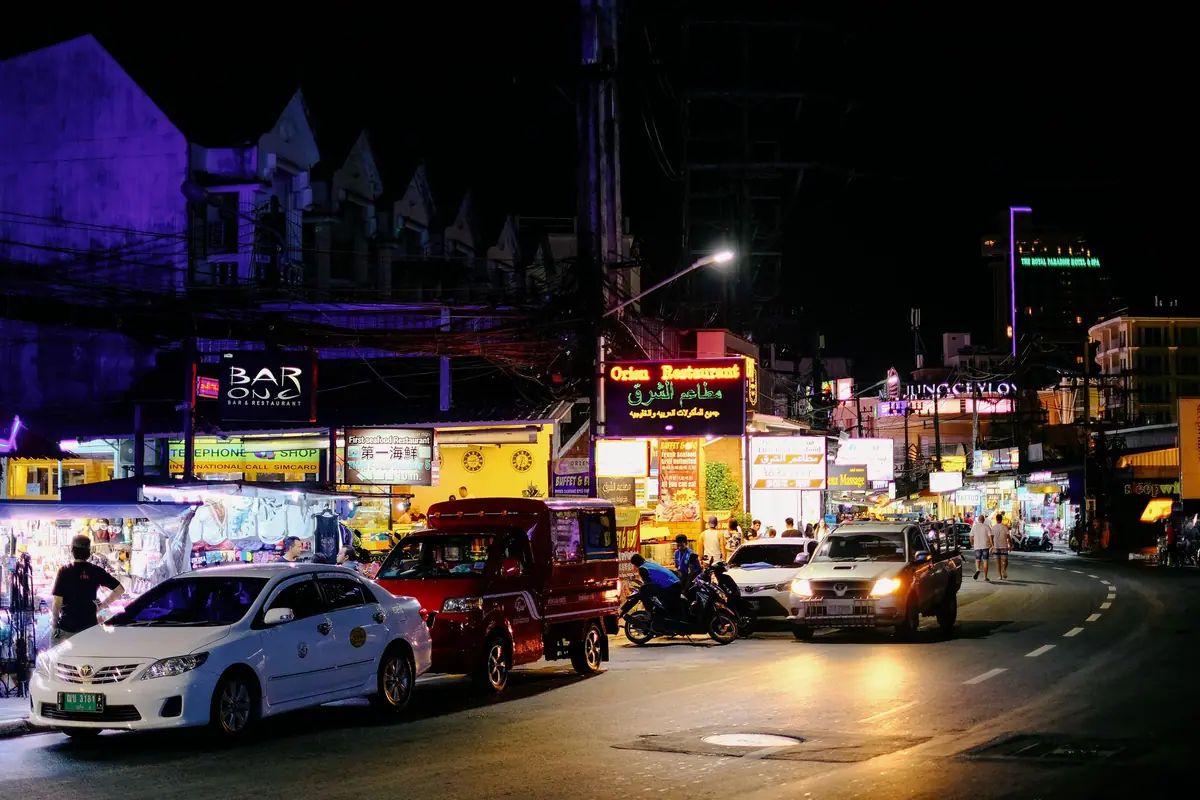 Evening traffic on a neon-lit street in Thailand