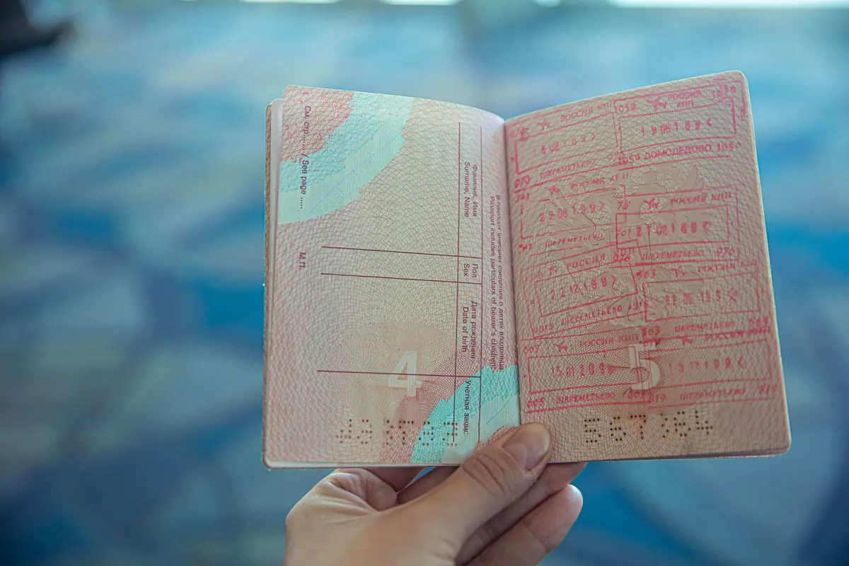 An open passport with entry stamps