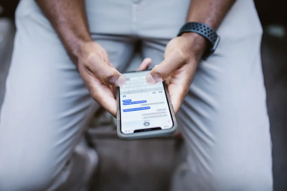 Hands holding a phone with an open chat
